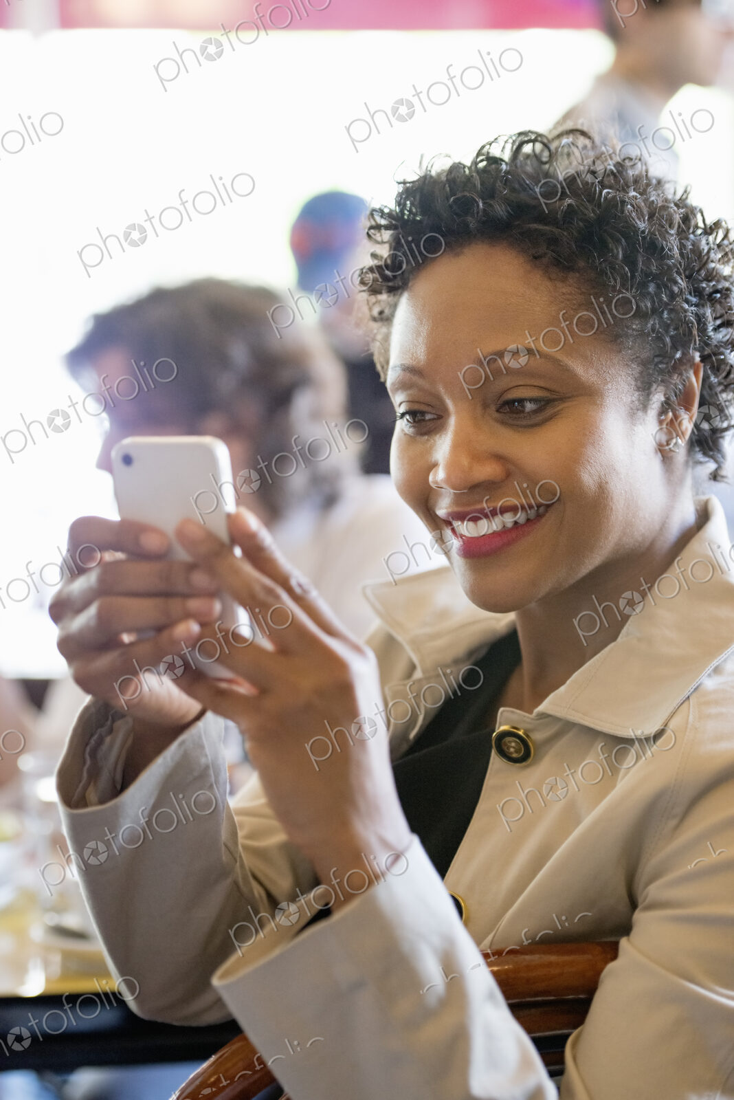 City life. A group of people sitting in a cafe or bar around a table. Men and women…