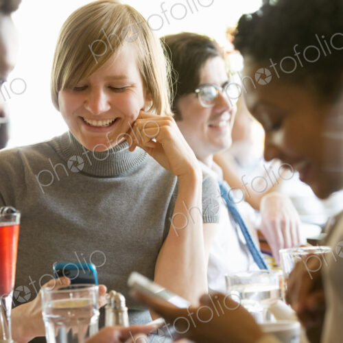 City life. A group of people sitting in a cafe or bar around a table. Men and women… City life. A group of people sitting in a cafe or bar around a table. Men and women…