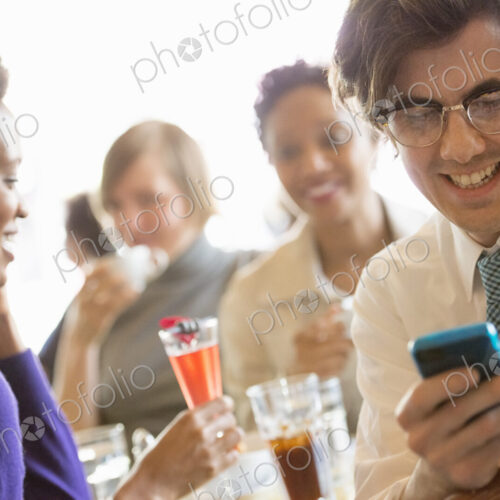 City life. A group of people sitting in a cafe or bar around a table. Men and women… City life. A group of people sitting in a cafe or bar around a table. Men and women…