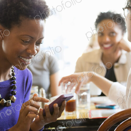 City life. A group of people sitting in a cafe or bar around a table. Men and women… City life. A group of people sitting in a cafe or bar around a table. Men and women…