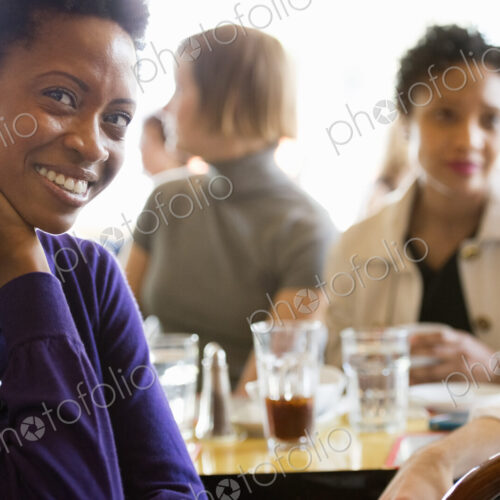 City life. A group of people sitting in a cafe or bar around a table. Men and women… City life. A group of people sitting in a cafe or bar around a table. Men and women…