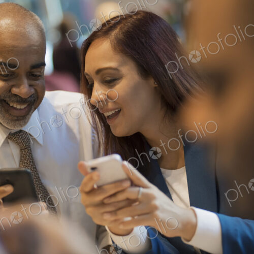 City life. A group of people sitting in a coffee shop, using mobile phones, and… City life. A group of people sitting in a coffee shop, using mobile phones, and…