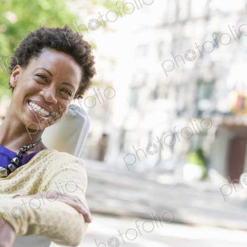 City life. A woman sitting in the open air in a city park.