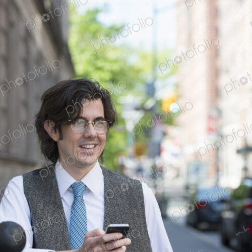 City life. People on the move. A young business man on the street checking his smart… City life. People on the move. A young business man on the street checking his smart…