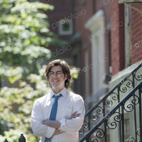 City life. People on the move. A young man in w white shirt and blue tie, standing… City life. People on the move. A young man in w white shirt and blue tie, standing…