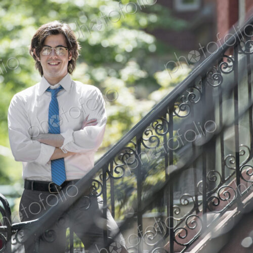City life. People on the move. A young man in w white shirt and blue tie, standing… City life. People on the move. A young man in w white shirt and blue tie, standing…