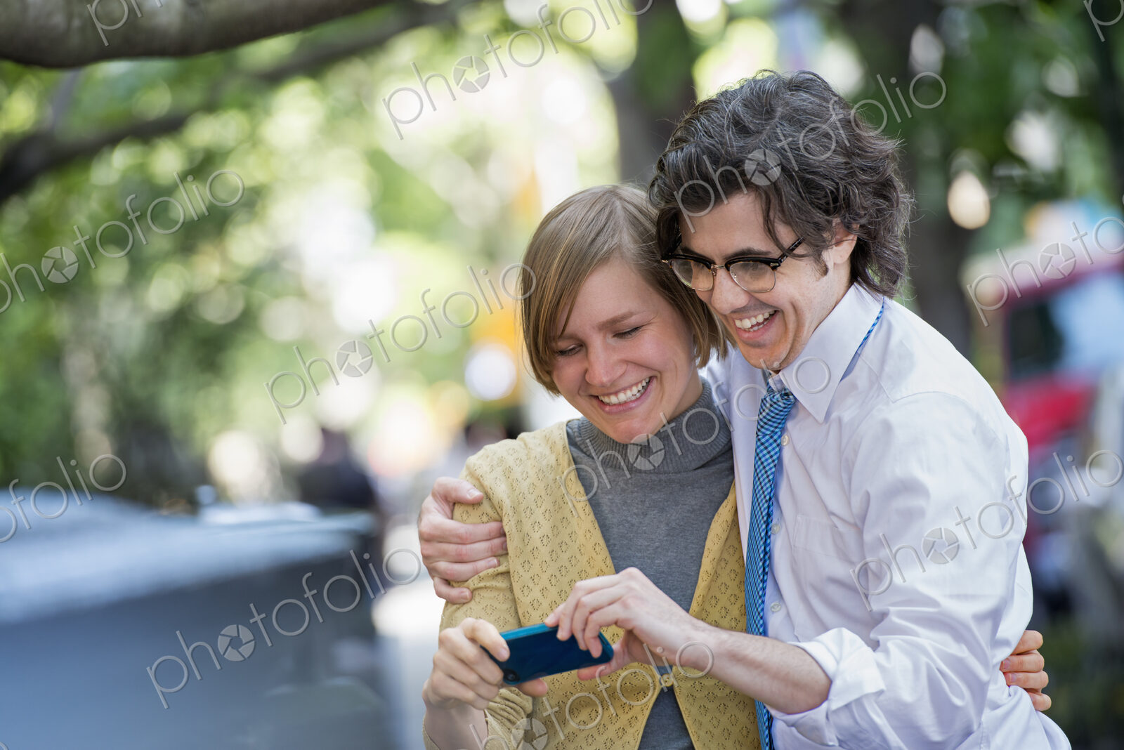 City life. People on the move. Two people, a man and woman outdoors, looking at a…