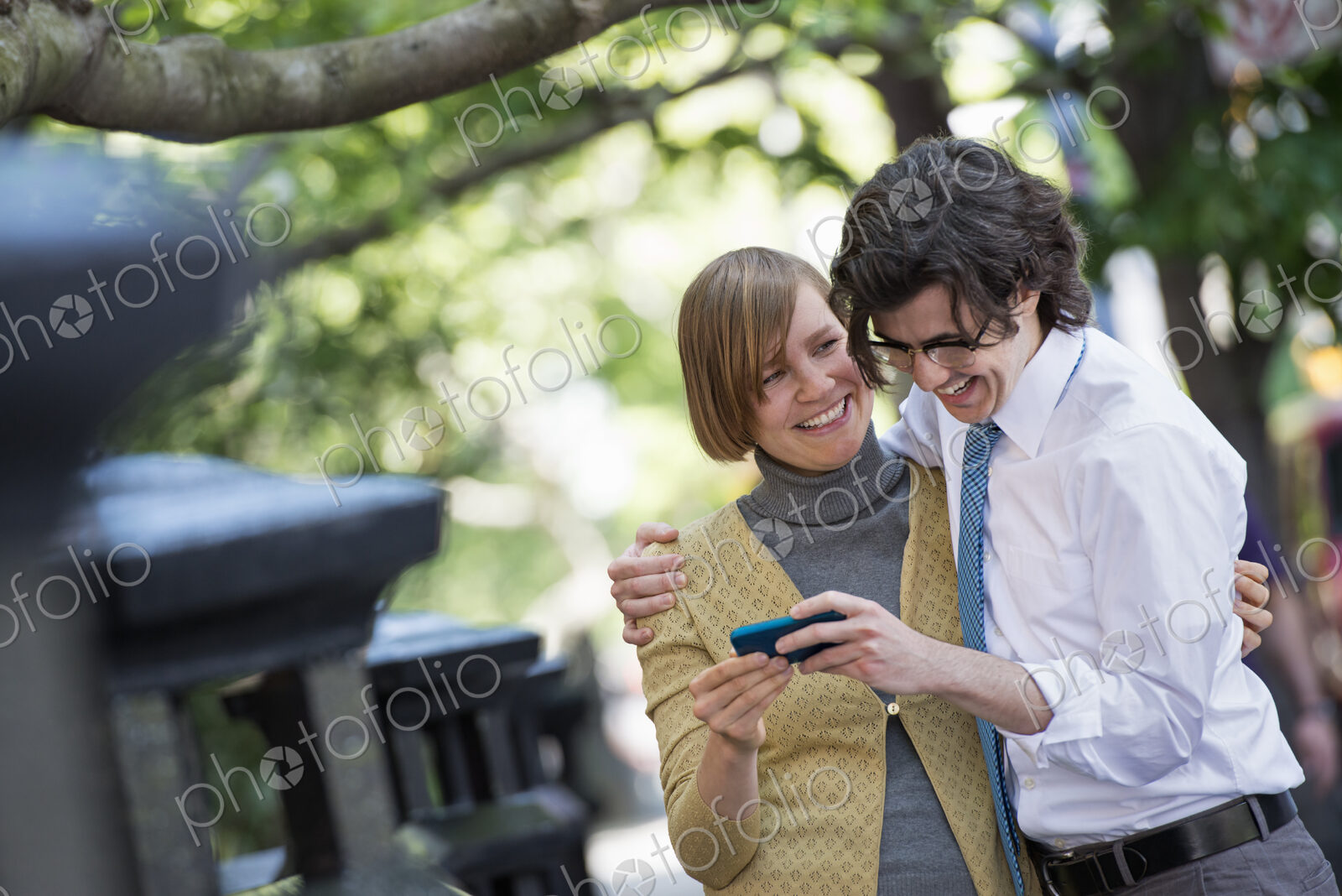 City life. People on the move. Two people, a man and woman outdoors, looking at a…