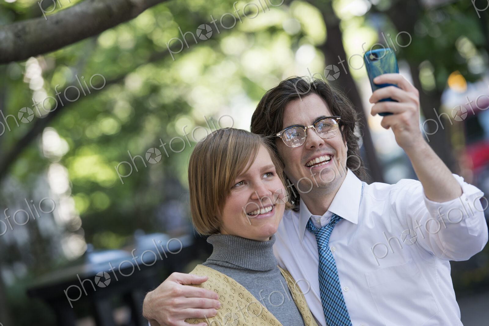City life. People on the move. Two people, a man and woman outdoors, side by side…