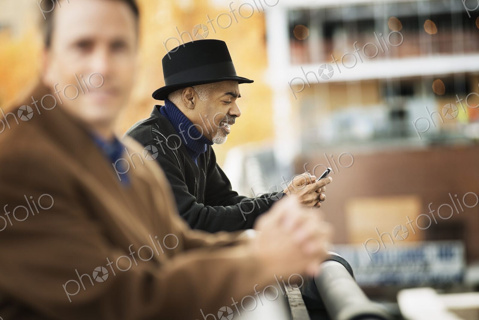 City life. Professional people on the go, keeping in contact, using mobile phones. Two…