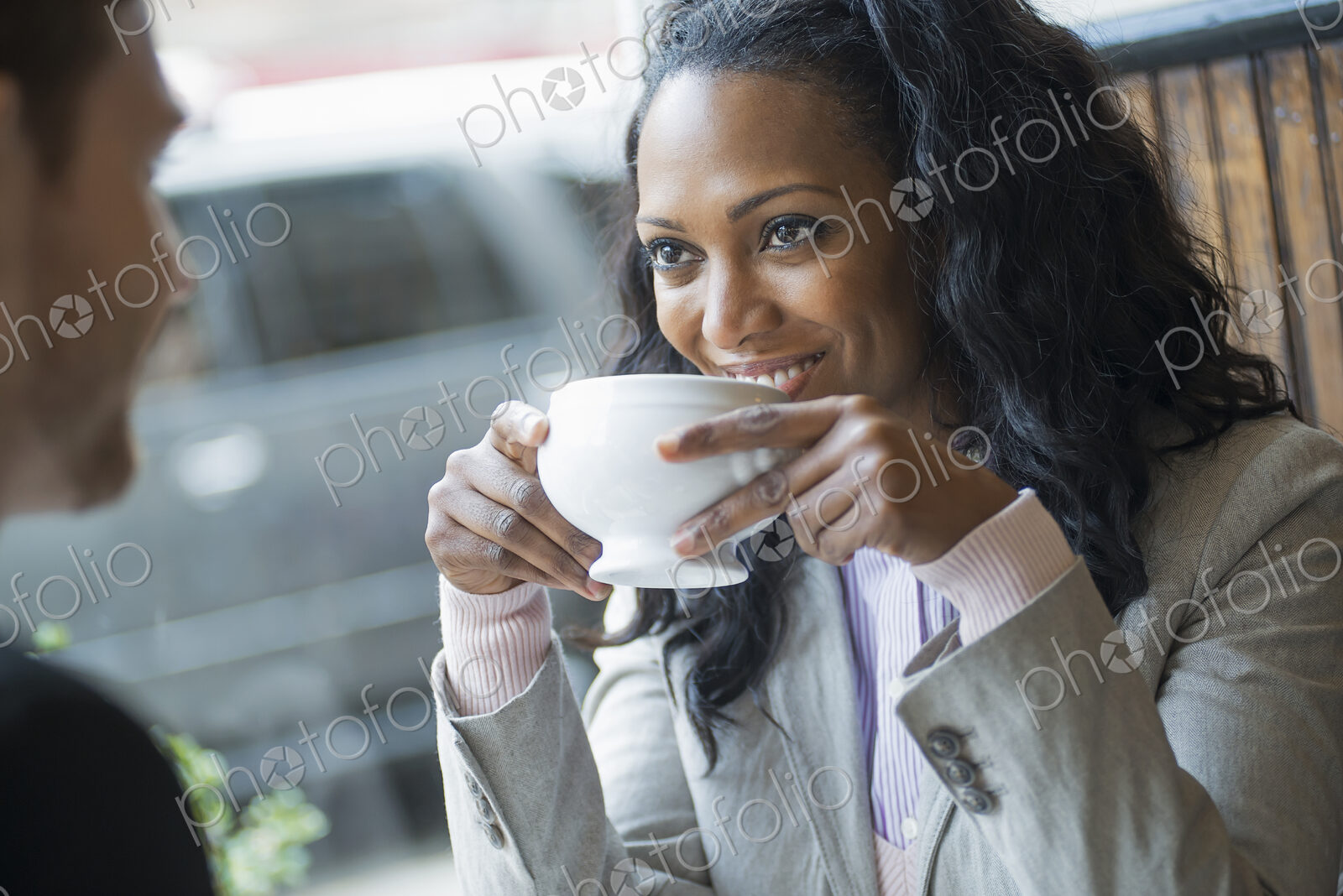 City life. Two people sitting in a coffee shop at a table. Man and woman.