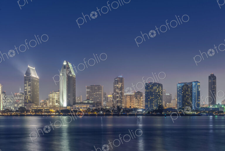City skyline lit up at night, San Diego, California, United States