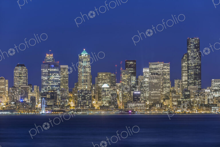 City skyline lit up at night, Seattle, Washington, United States