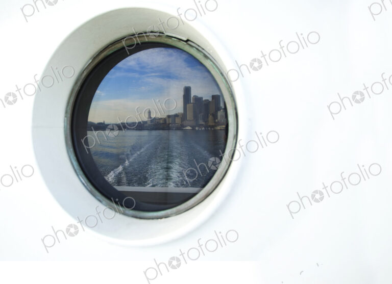 City skyline reflected in ferry porthole, Seattle, Washington, United States