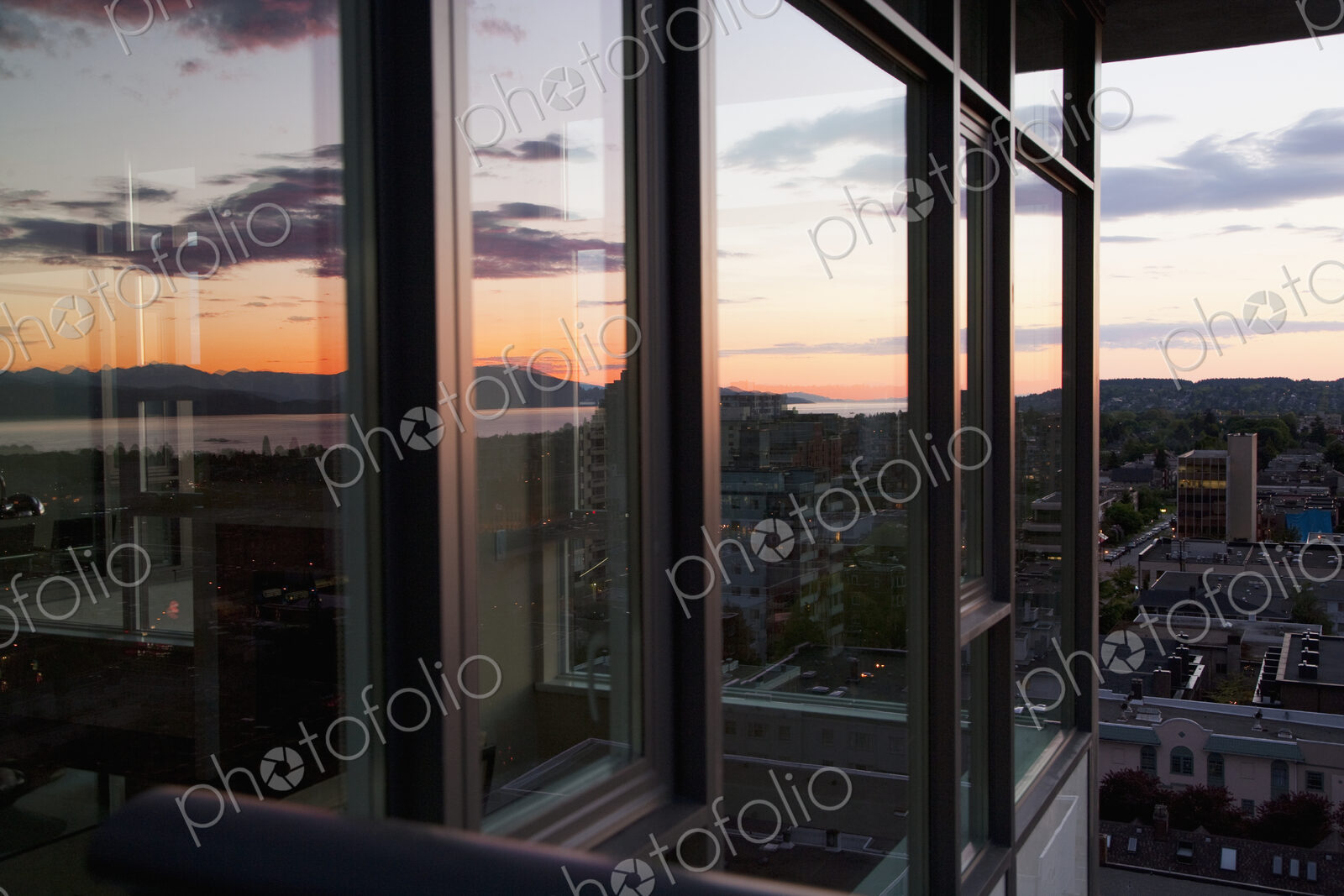 City view at dusk from an open window in an apartment