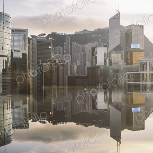Cityscape with modern skyscrapers reflected in calm sea. Cityscape with modern skyscrapers reflected in calm sea.