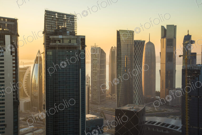 Cityscape with tall modern skyscrapers at dusk.
