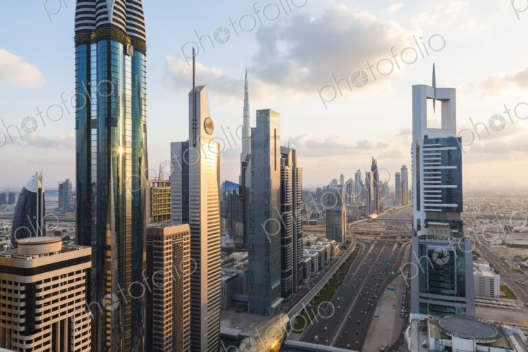 Cityscape with tall modern skyscrapers under a cloudy sky.