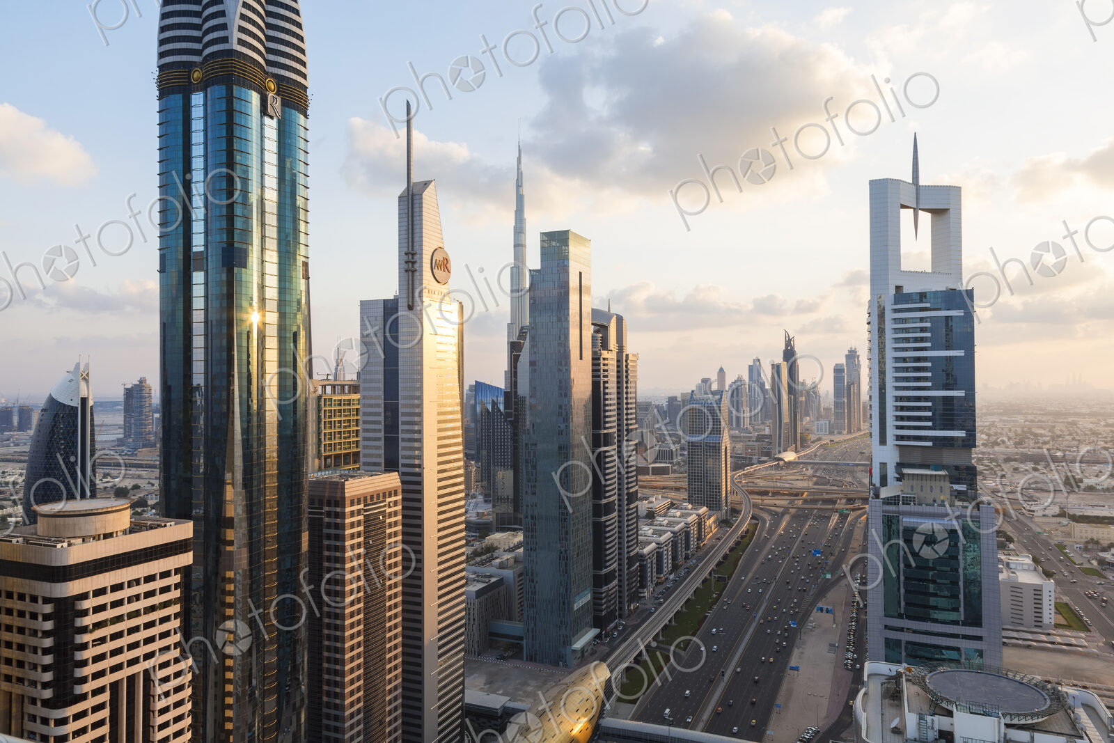 Cityscape with tall modern skyscrapers under a cloudy sky.