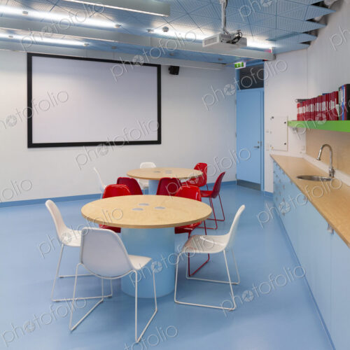 Classroom with white board, round tables and counter and sink Classroom with white board, round tables and counter and sink
