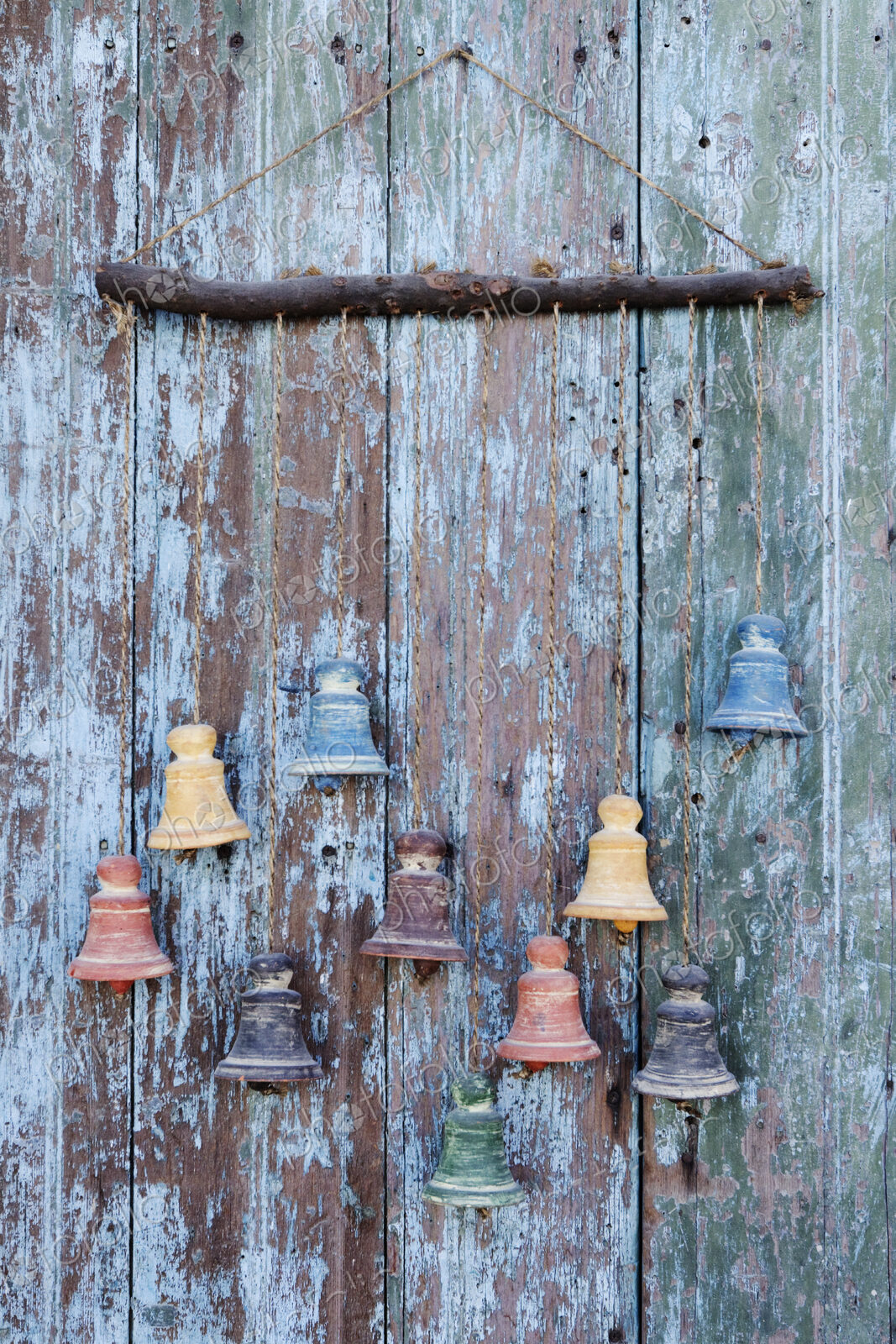 Clay bells hanging from a weathered door