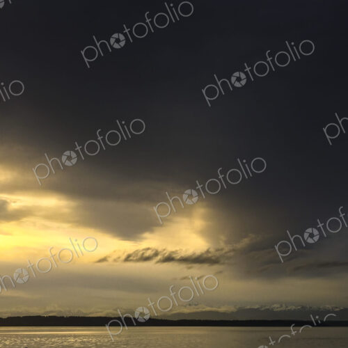 Clearing storm over Puget Sound, clouds making way for sunshine.
