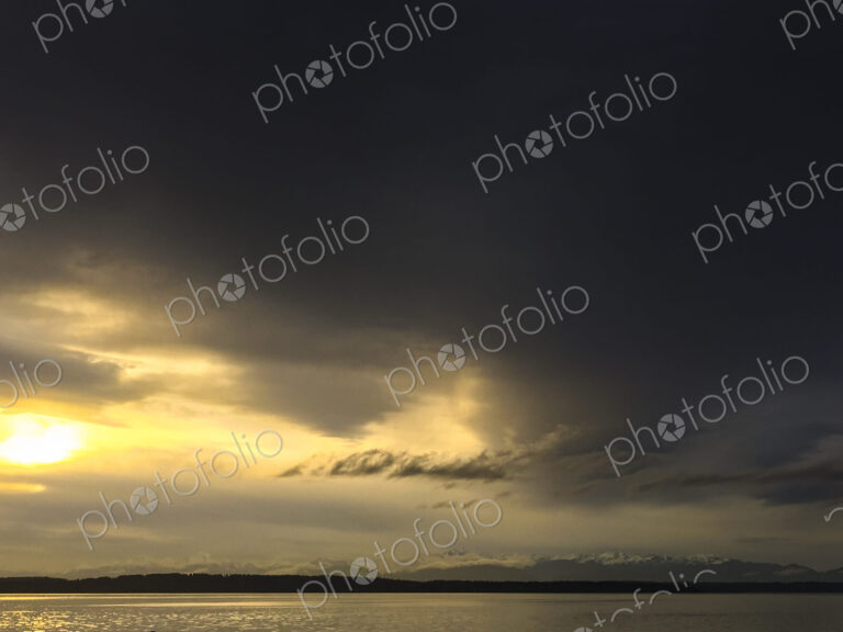 Clearing storm over Puget Sound, clouds making way for sunshine.