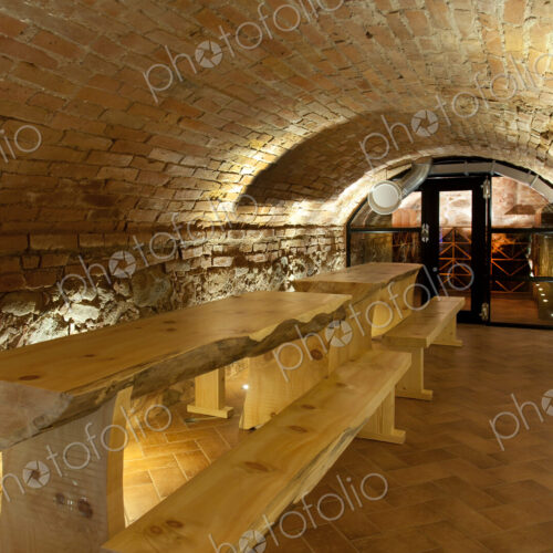 Climate controlled wine cellar, with a domed brick ceiling and walls, stacked benches