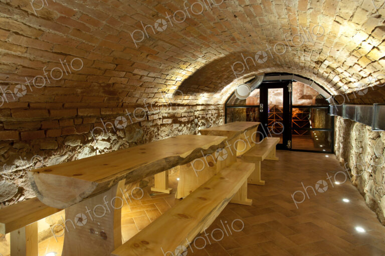 Climate controlled wine cellar, with a domed brick ceiling and walls, stacked benches