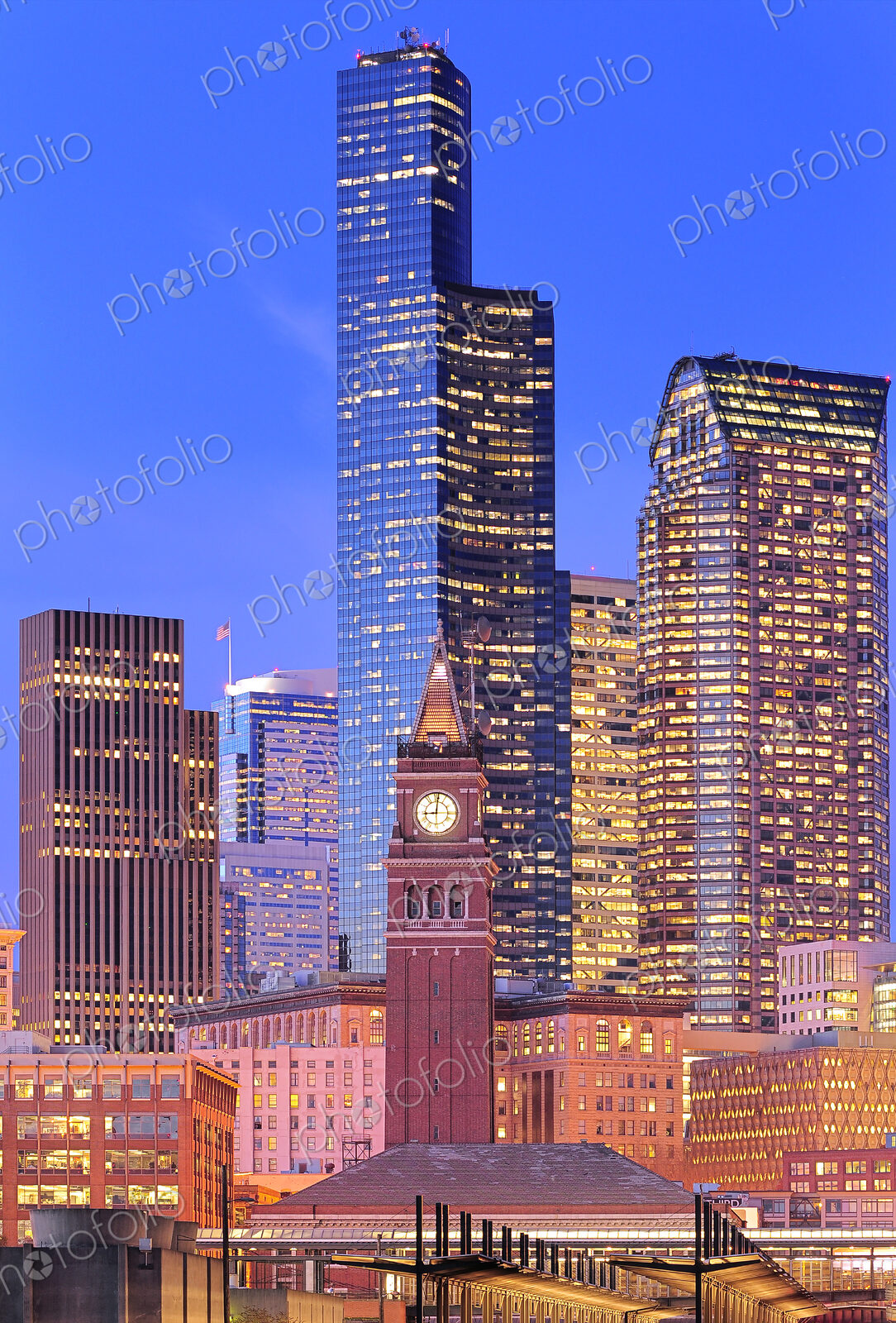 Clock tower and illuminated high rise buildings in Seattle city skyline, Washington,…