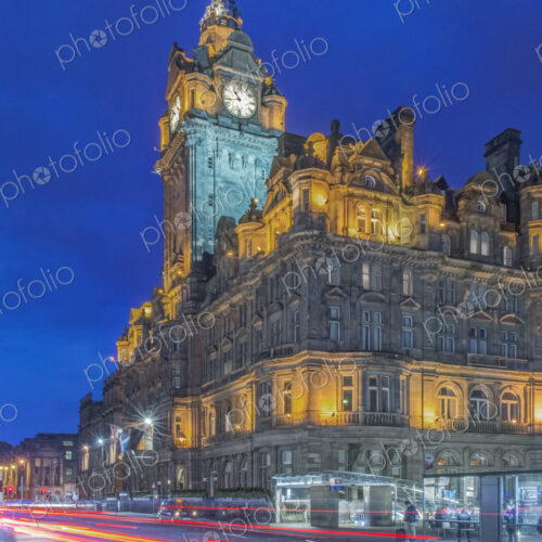 Clock tower of Balmoral Hotel lit up at night with traffic light blur below. Clock tower of Balmoral Hotel lit up at night with traffic light blur below.