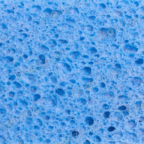 Close up full frame of a blue cleaning sponge with a pitted porous surface, a plastic… Close up full frame of a blue cleaning sponge with a pitted porous surface, a plastic…
