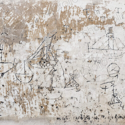 Close up of 18th century graffiti of sailboats on a wall. Close up of 18th century graffiti of sailboats on a wall.