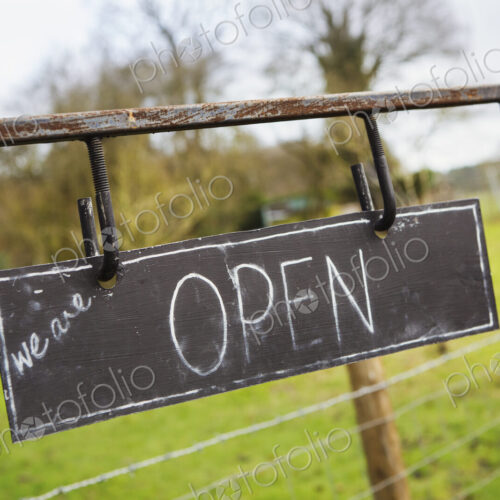 Close up of 'Open' sign on a fence at a farm shop. Close up of 'Open' sign on a fence at a farm shop.