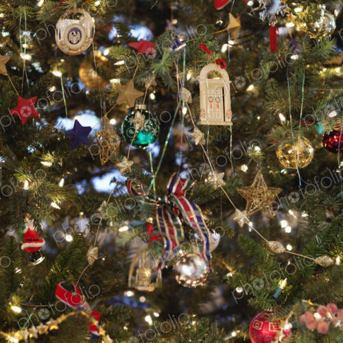 Close up of a Christmas tree, pine tree branch crowded with ornaments