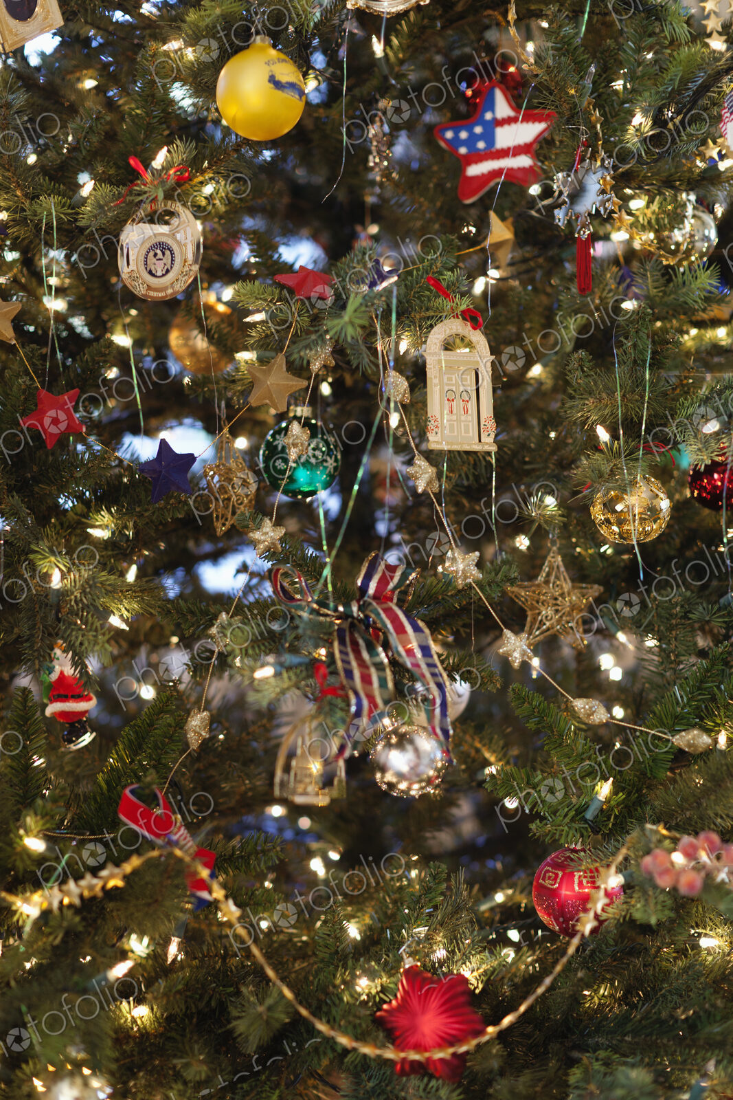 Close up of a Christmas tree, pine tree branch crowded with ornaments
