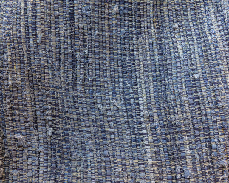 Close up of a blue and brown sewn recycled rag rug.