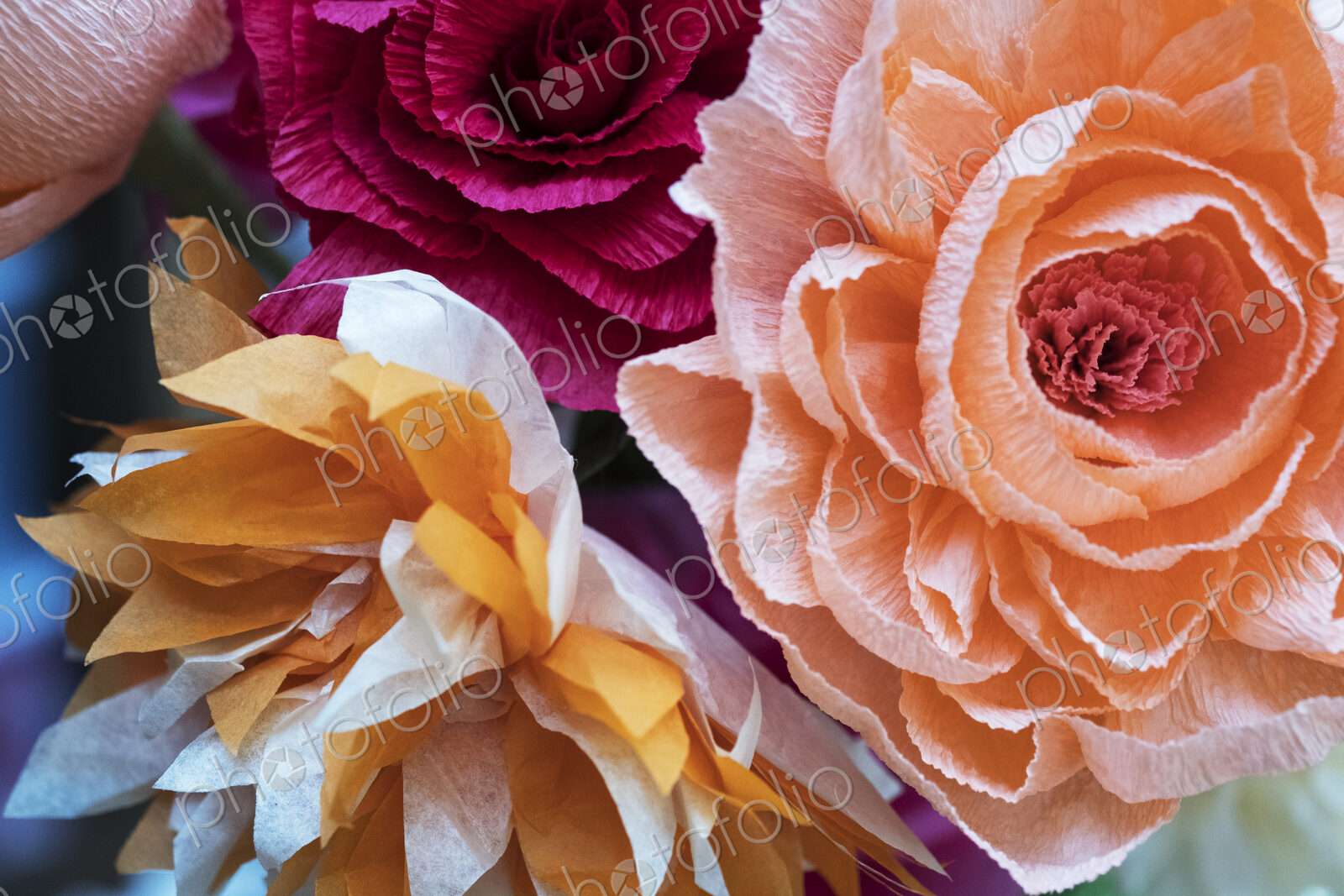 Close up of a bunch of colourful handcrafted fabric flowers.