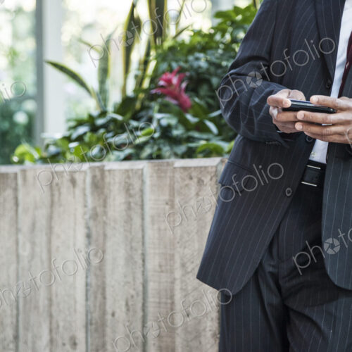 Close-up of a business man texing on a cell phone. Close-up of a business man texing on a cell phone.