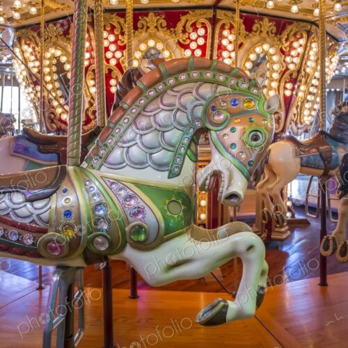 Close-up of a colorful carousel horse on a Merry Go Round decorated with jewels and… Close-up of a colorful carousel horse on a Merry Go Round decorated with jewels and…