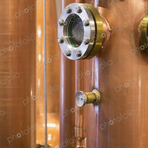 Close up of a copper still in a distillery, Washington, USA. Close up of a copper still in a distillery, Washington, USA.