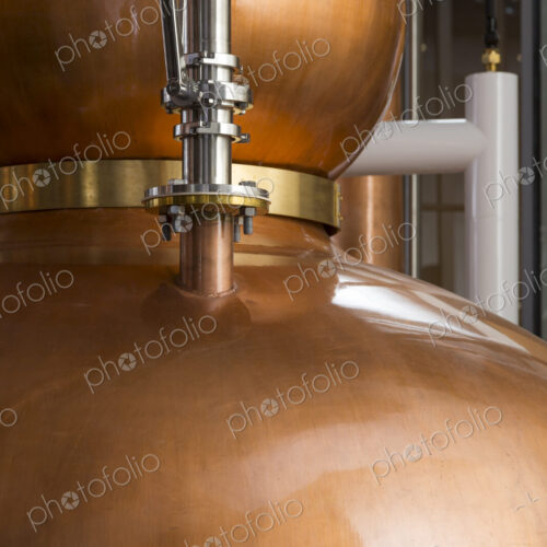Close up of a copper still in a distillery, Washington, USA. Close up of a copper still in a distillery, Washington, USA.