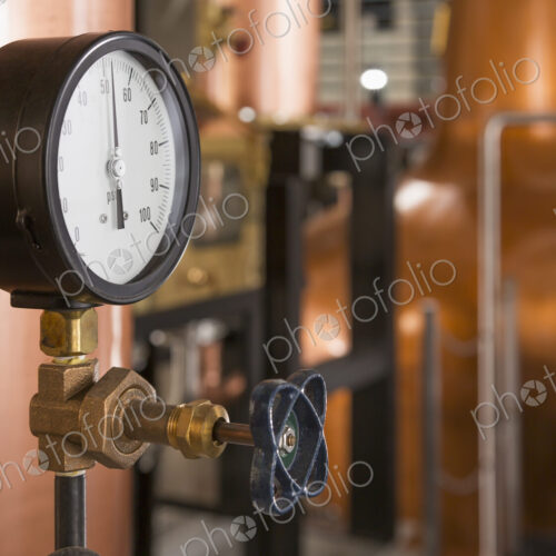 Close up of a copper still in a distillery, Washington, USA. Close up of a copper still in a distillery, Washington, USA.