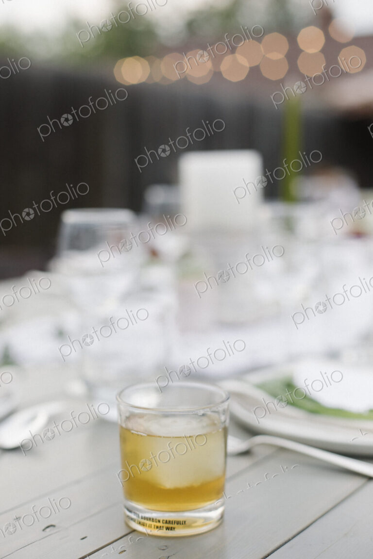 Close up of a drink on a table in a garden.