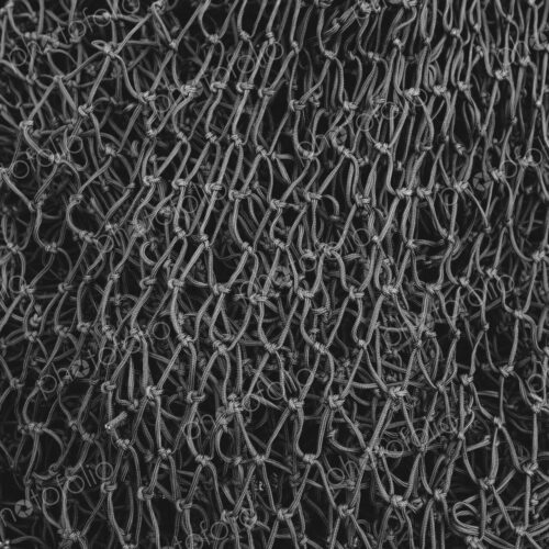 Close up of a grey commercial fishing nets. Close up of a grey commercial fishing nets.
