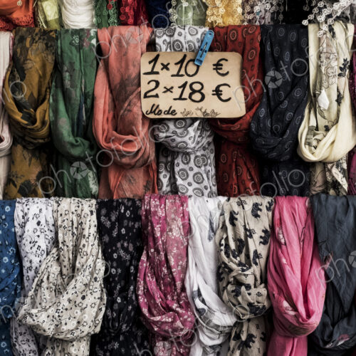 Close up of a large selection of colourful scarves at a market stall. Close up of a large selection of colourful scarves at a market stall.