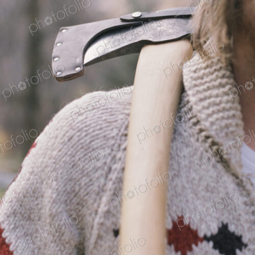 Close up of a man carrying an axe on his shoulder. Close up of a man carrying an axe on his shoulder.