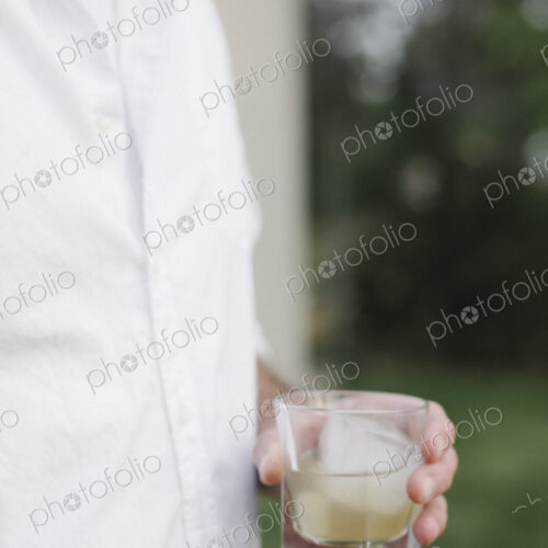 Close up of a man standing in a garden, holding a drink. Close up of a man standing in a garden, holding a drink.
