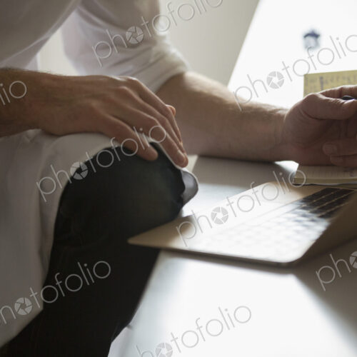 Close up of a man working on a laptop computer. Close up of a man working on a laptop computer.