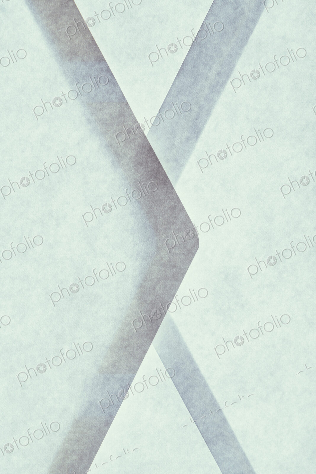 Close up of a paper envelope with glued borders, above a light source.